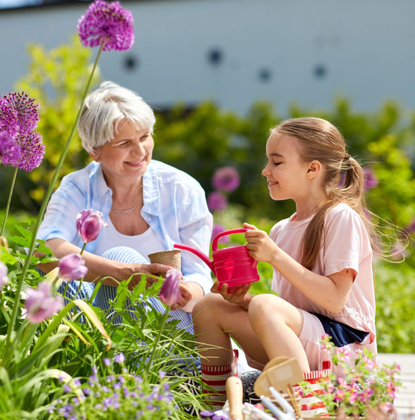 Retired Grandmother Gardening with Grandchild