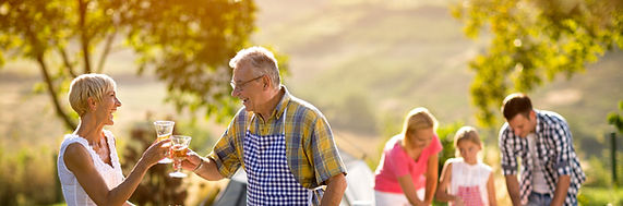 Retire couple enjoying a bbq with family
