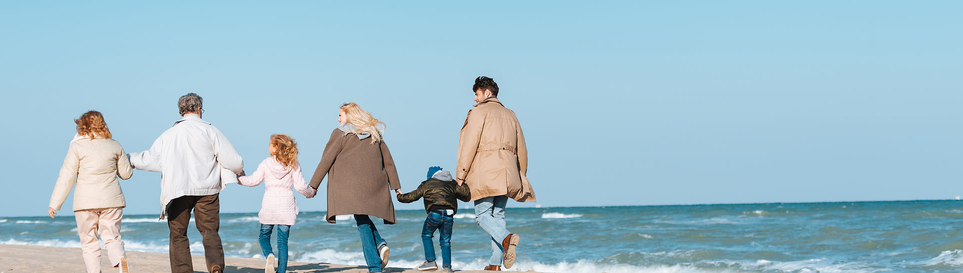 Family enjoying the beach - retirement, family, legacy